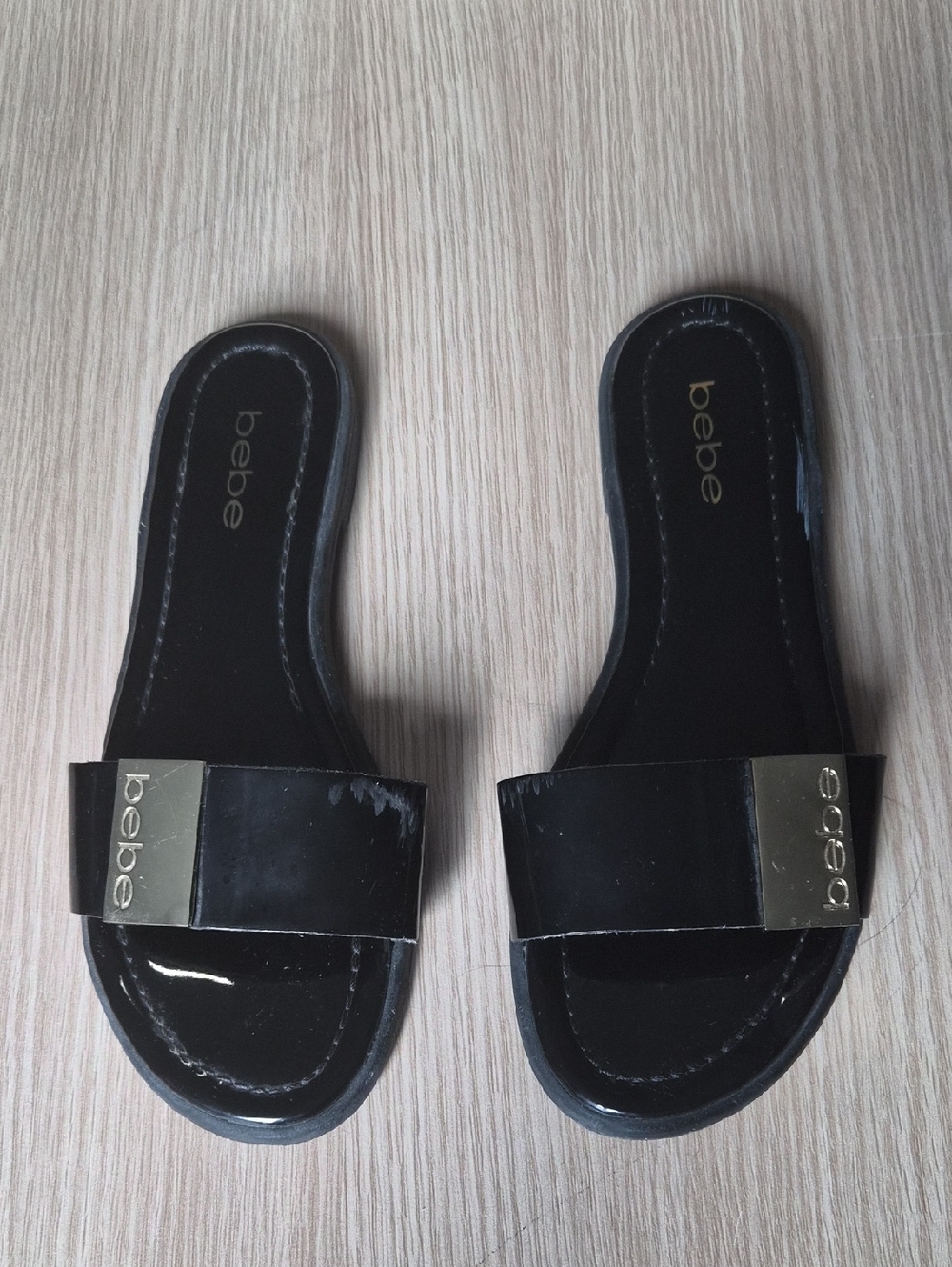 bebe Black Patent Slide Sandals with Gold Logo Plaque